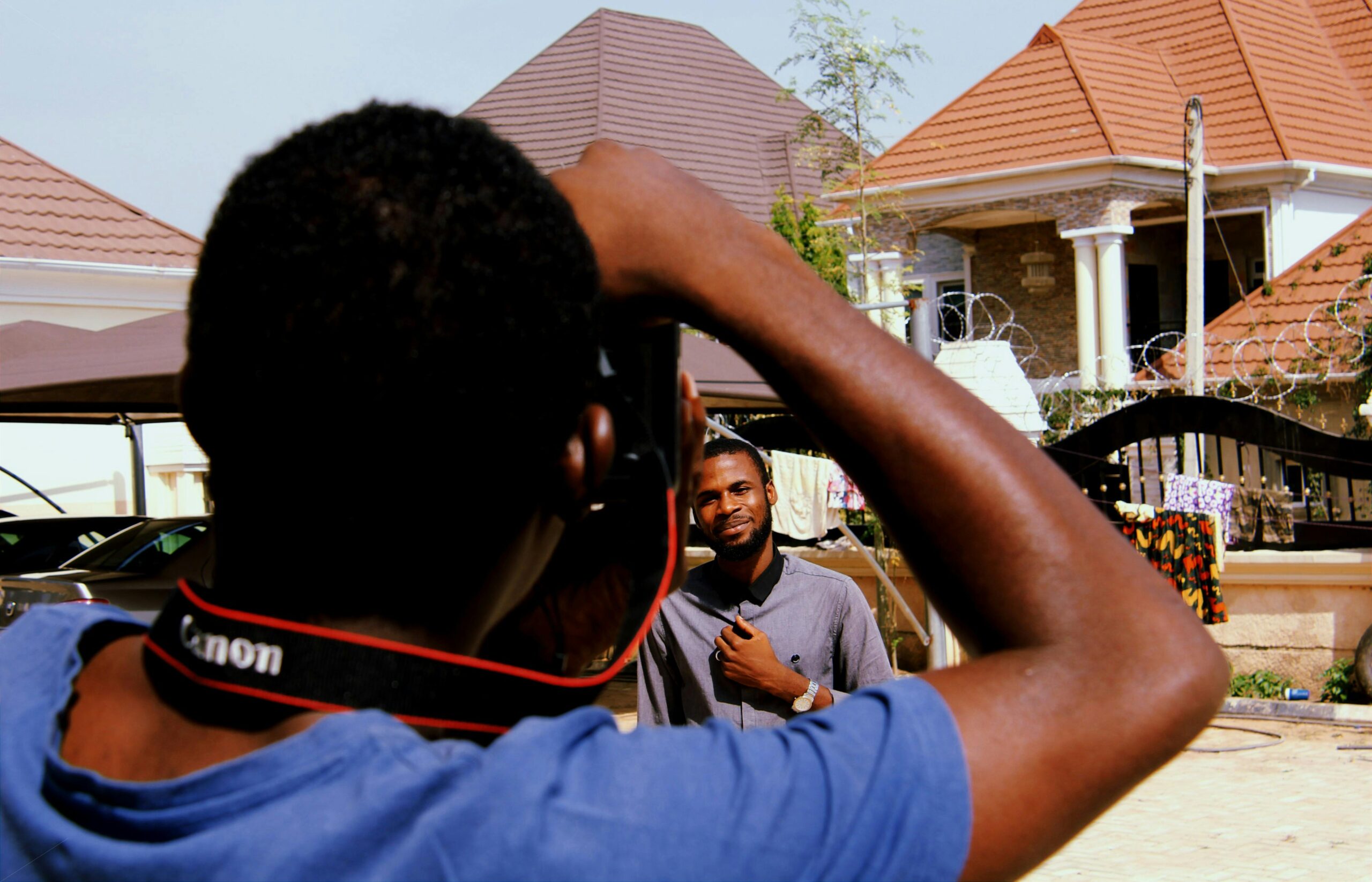 Home A casual outdoor photoshoot featuring young men in an urban setting.